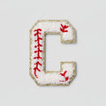 Embroidered letter 'C' patch on a textured fabric background